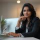 generate a indian female professional image sitting in office